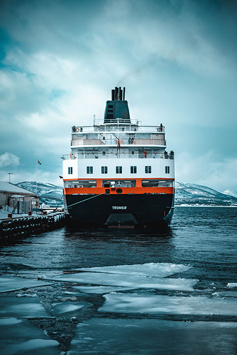 A ship is sailing through ice